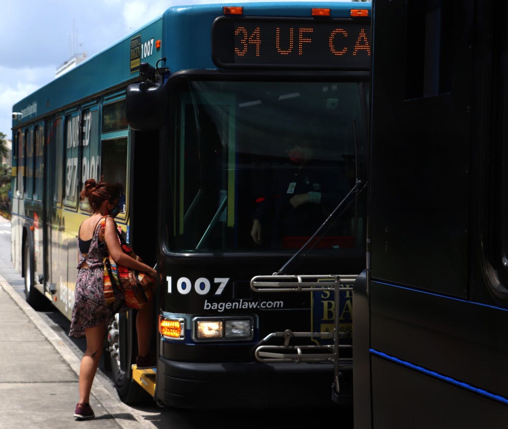 <p>UF first-year interdisciplinary ecology PH.D. student, Natalia Uribe, 29, boards RTS bus No. 34 on Wednesday, September 2, 2020. Uribe said she thinks the buses are safe and that not many people are using them.</p>