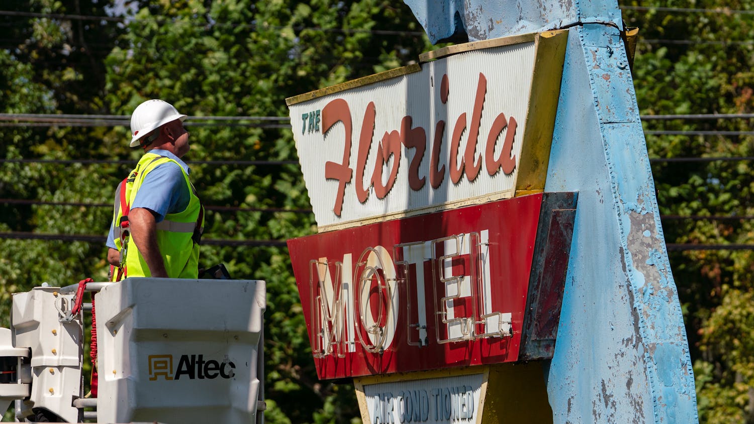 Construction workers dismantle the iconic Florida Motel sign on Southwest 13th Street Wednesday afternoon. It took six hours and a five-person crew.