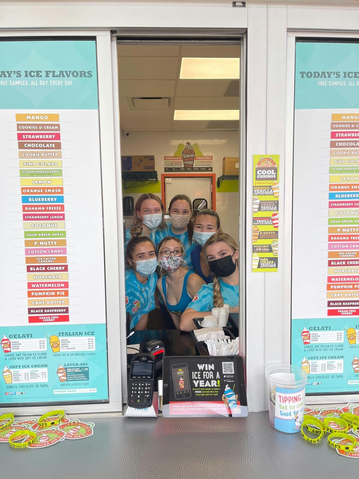Jeremiah&#x27;s employees gather by the order window at the store&#x27;s grand opening Oct. 26.
