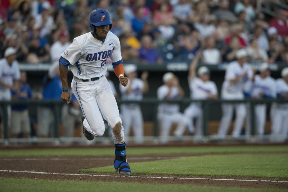 <p>Florida's Buddy Reed runs toward first base during the Gators' 15-3 victory against Miami in the NCAA Men's College World Series on Saturday, June 13, 2015 at TD Ameritrade Park in Omaha.</p>