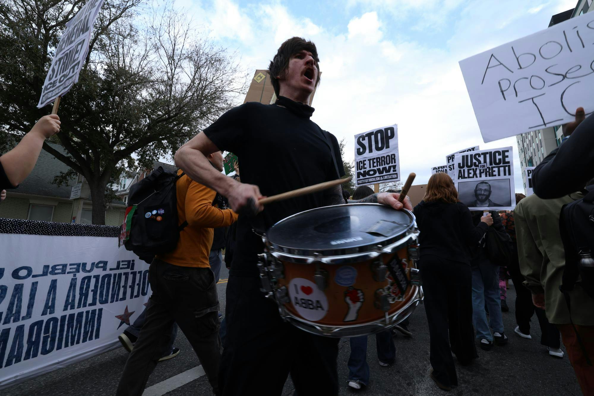 A protestor bangs on drums during an anti-ICE protest while marching down University Ave. in Gainesville, Fla., Friday, Jan. 30, 2026.