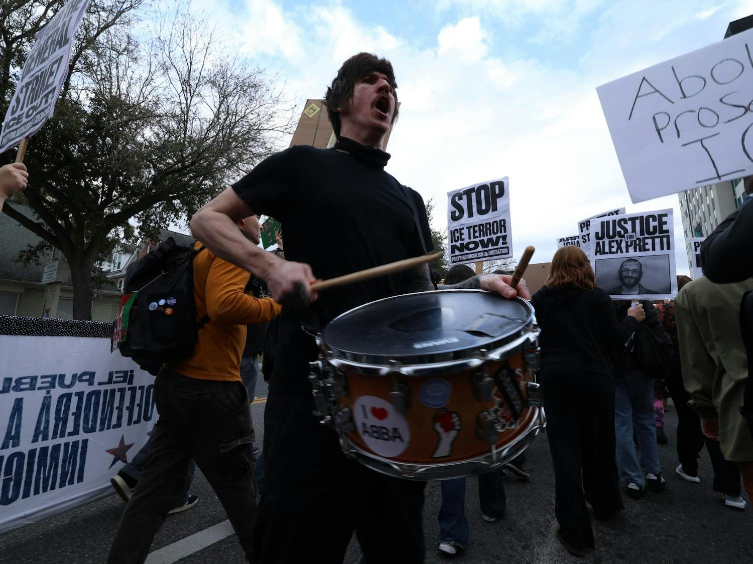 A protestor bangs on drums during an anti-ICE protest while marching down University Ave. in Gainesville, Fla., Friday, Jan. 30, 2026.