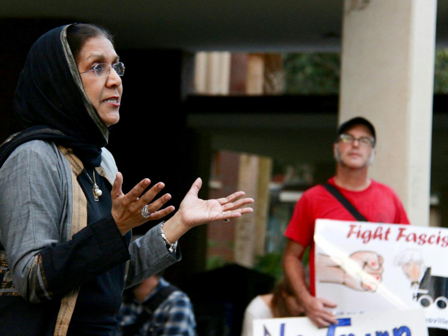 Indian-American immigrant Aqueela Khuddus, 63, explains to a group of about 30 people how welcoming Americans were when she emigrated to the U.S. about 50 years ago. The director of a nonprofit organization, the Khadija Foundation, was one of five speakers at the Rally Against Fascism and Xenophobia held on the Plaza of the Americas on Monday night.