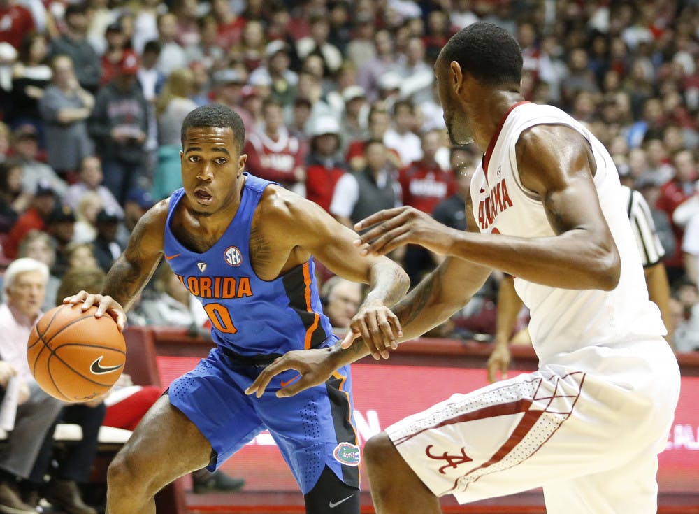 <p>Florida guard Kasey Hill drives the ball against Alabama forward Jimmie Taylor during the first half of an NCAA college basketball game, Tuesday, Jan. 10, 2017, in Tuscaloosa, Ala. (AP Photo/Brynn Anderson)</p>