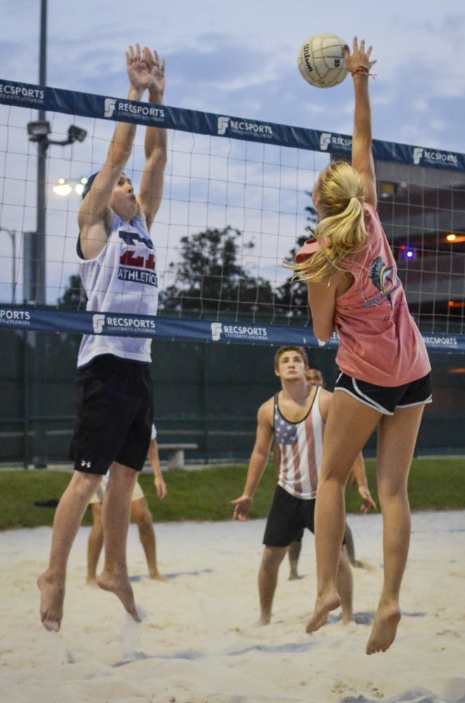 Drew Baker, a 20-year-old UF economics major, prepares to block a spike from 20-year-old aerospace engineer major Shanna Wyatt. The volleyball game was part of “Spike-it-with-Senate,” a charity volleyball tournament.