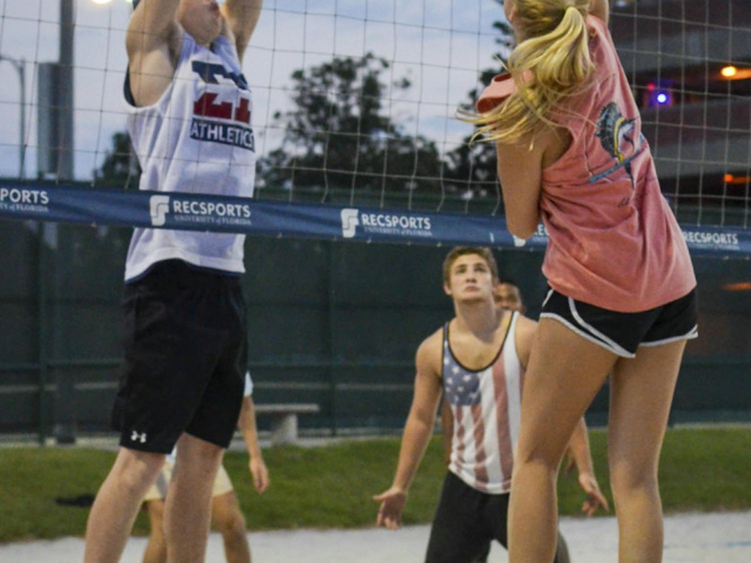 Drew Baker, a 20-year-old UF economics major, prepares to block a spike from 20-year-old aerospace engineer major Shanna Wyatt. The volleyball game was part of “Spike-it-with-Senate,” a charity volleyball tournament.