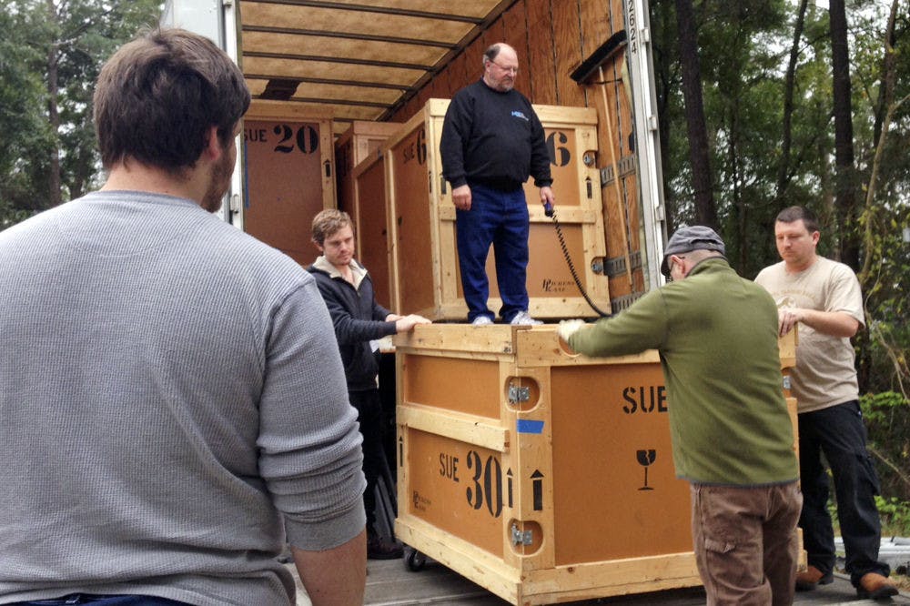 Dale Neubauer, 65, supervises workers from the Florida Museum of Natural History and the Phillips Center for Performing Arts Center unload one of the crates in which Sue’s bones are packed. Each crate weighs about a ton.