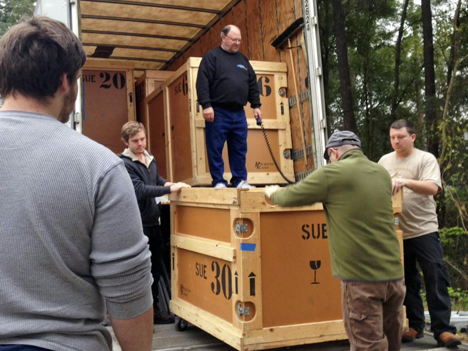 Dale Neubauer, 65, supervises workers from the Florida Museum of Natural History and the Phillips Center for Performing Arts Center unload one of the crates in which Sue’s bones are packed. Each crate weighs about a ton.