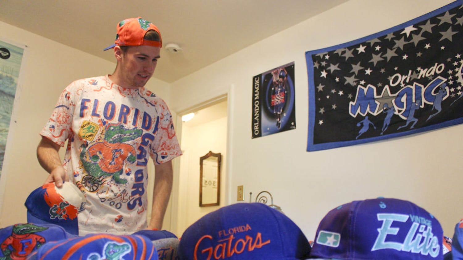 Josh Rittenour, a 20-year-old UF economics junior, lays out a portion of sports hats that he has collected through thrifting at his house on Sept. 24, 2015. Rittenour restores the old hats. “It’s something that I have and can bring back to life and let someone else enjoy as much as the original person,” he said.