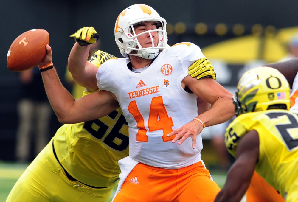 <p>Tennessee quarterback Justin Worley (14) is sacked by Oregon defensive tackle Taylor Hart (66) during UT's 59-14 los in Eugene, Ore., Saturday, Sept. 14, 2013.</p>