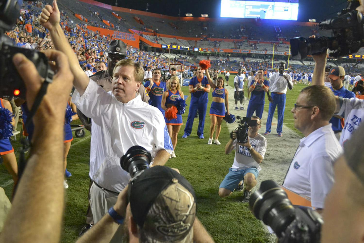 Surrounded by media, Jim McElwain celebrates Florida's 61-13 win against New Mexico State on Sept. 5, 2015. This was his first game as head UF football coach.
