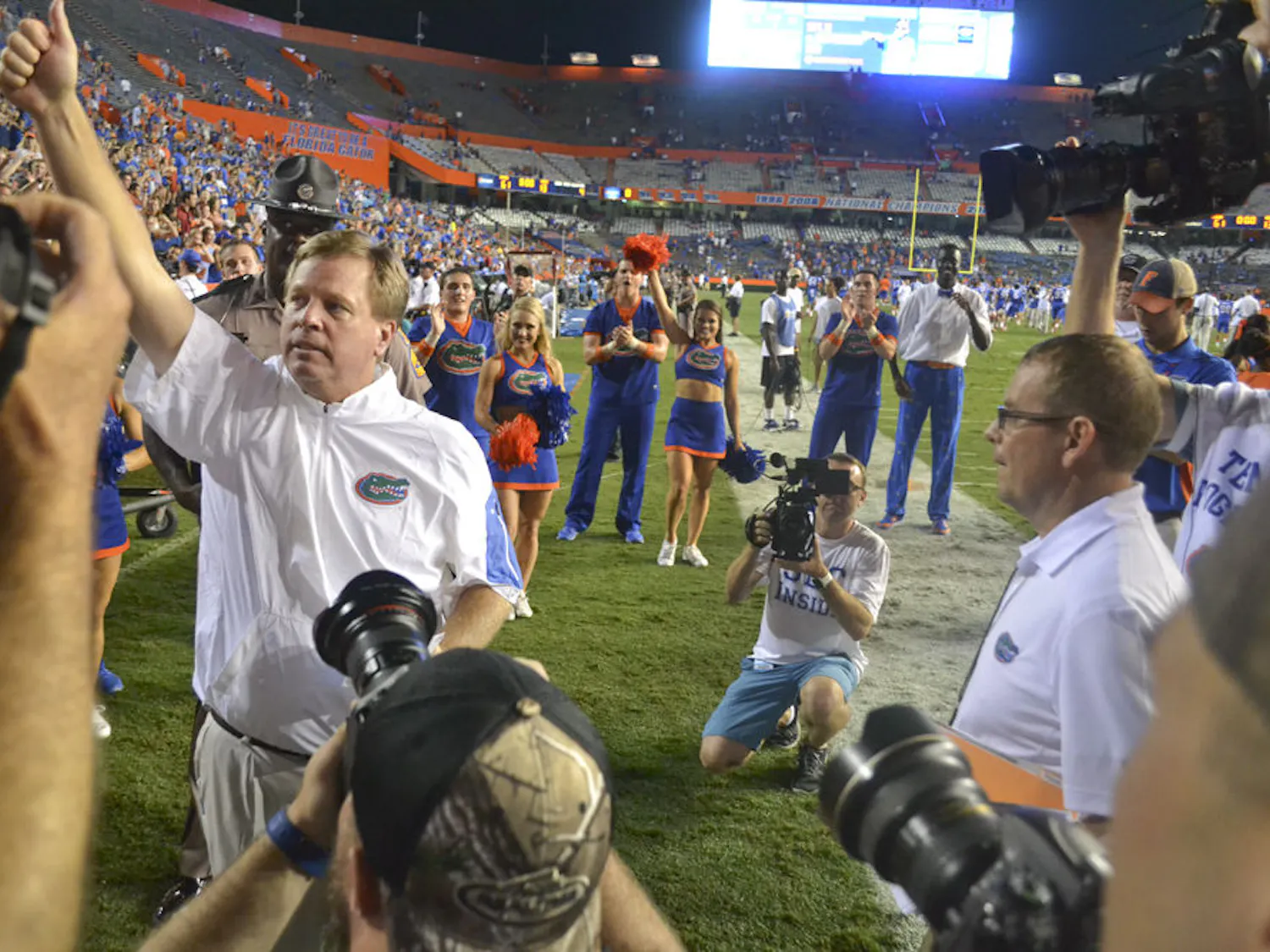 Surrounded by media, Jim McElwain celebrates Florida's 61-13 win against New Mexico State on Sept. 5, 2015. This was his first game as head UF football coach.