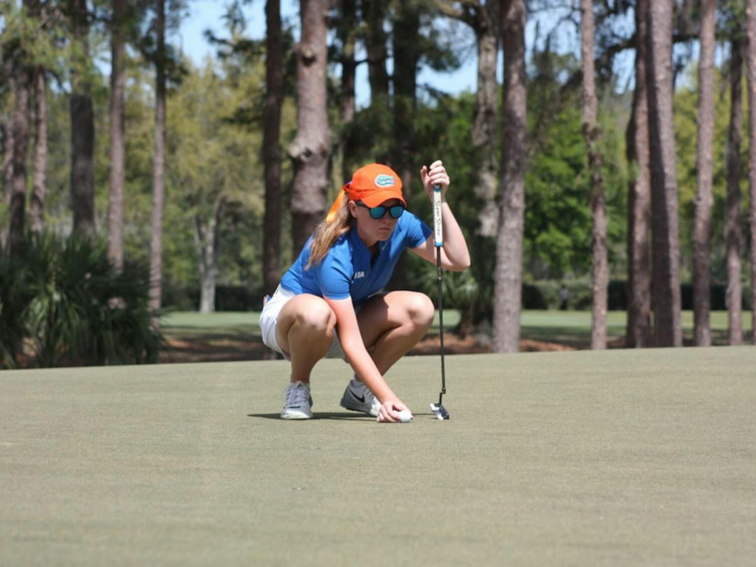 Junior Addie Baggarly kneels down to contemplate a putt. Her teammate&nbsp;Annabell Fuller came in second at the Amateur&nbsp;Women’s Championship this past weekend.