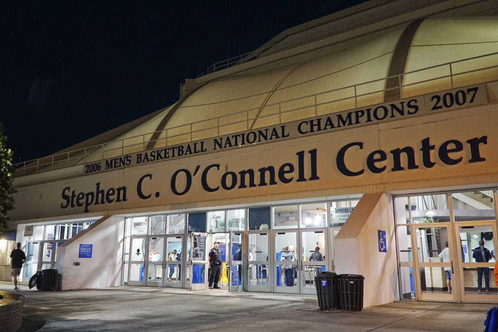 Spectators and security staff use the Stephen C. O’Connell Center before the volleyball game Thursday.