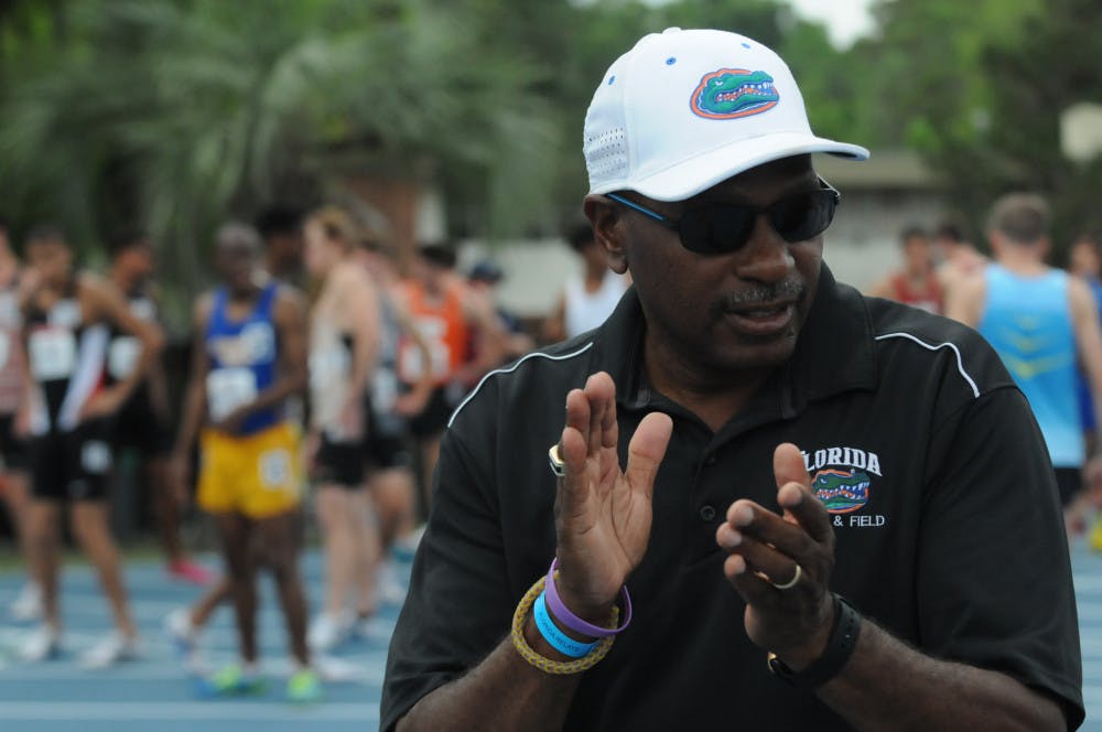 Coach Mike Holloway claps as he watches his team.