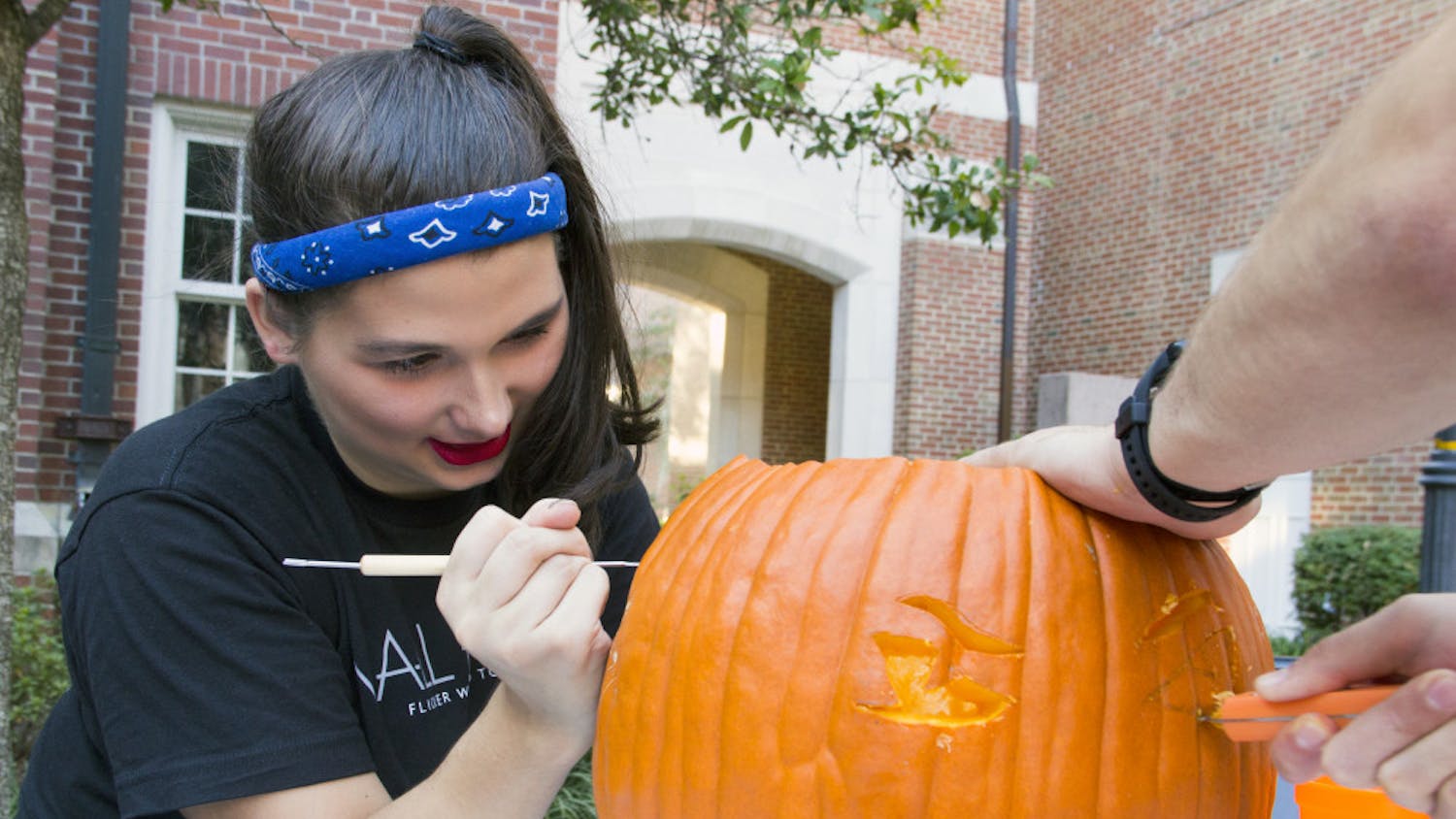 Rhyan Nedobity, a 19-year-old UF accounting sophomore, carves a pumpkin monday during the Pumpkin Palooza Leadership Venture at the Heavener Hall courtyard. Hosted by the Warrington Diplomats, the organization holds events that focus on professional development every semester.