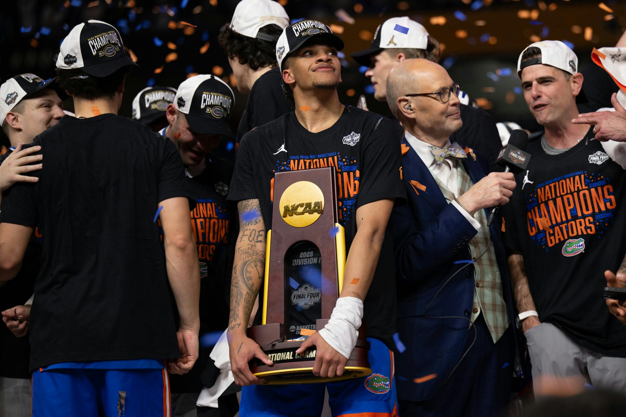 Florida Gators guard Will Richard (5) holds the national championship trophy and smiles after winning the National Championship against the Houston Cougars in the NCAA Tournament on Monday, April 7, 2025, in San Antonio, Texas.