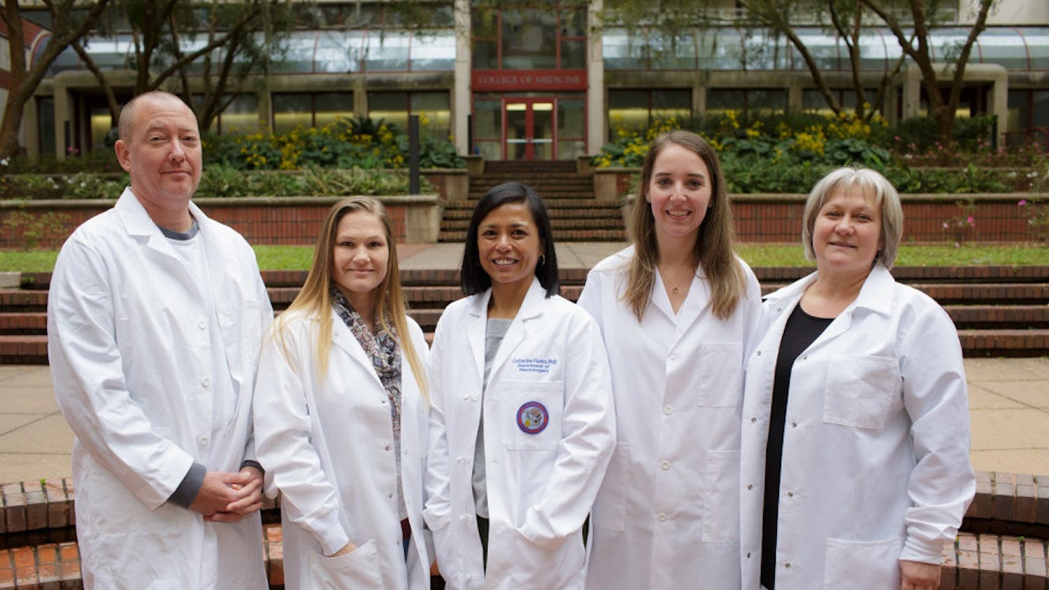 Catherine Flores (middle) stand with other members of the UF Brain Tumor Immunotherapy Program. As principal investigator of the program, Flores researches how to fight brain tumors in children.