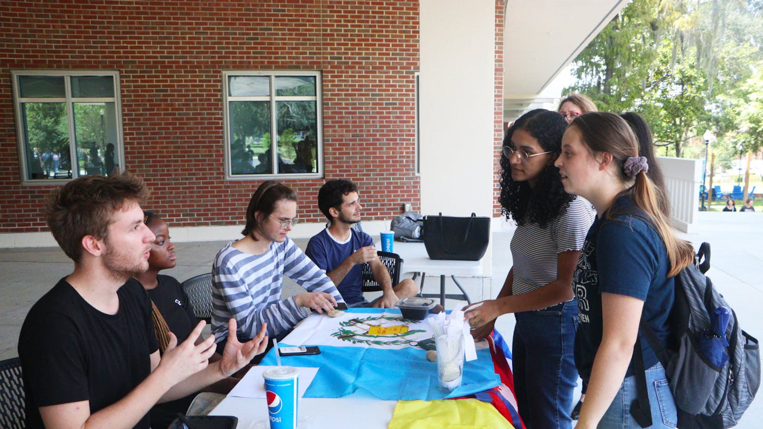 The Davis United World College Scholars talk to students while tabling outside the Reitz Union on Wednesday, Sep. 21, 2022.