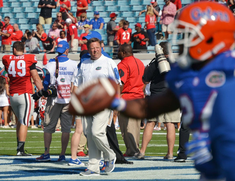 <p>UF coach Jim McElwain watches on during warm-ups prior to Florida's 27-3 win against Georgia on Oct. 31, 2015, at EverBank Field in Jacksonville.</p>