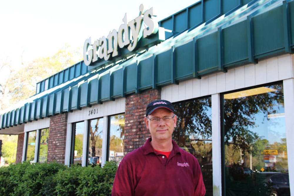 <p class="p1">Grandy’s franchise owner Dave Miles stands in front his restaurant on the corner of West University Avenue and Southwest 34th Street on Thursday.</p>