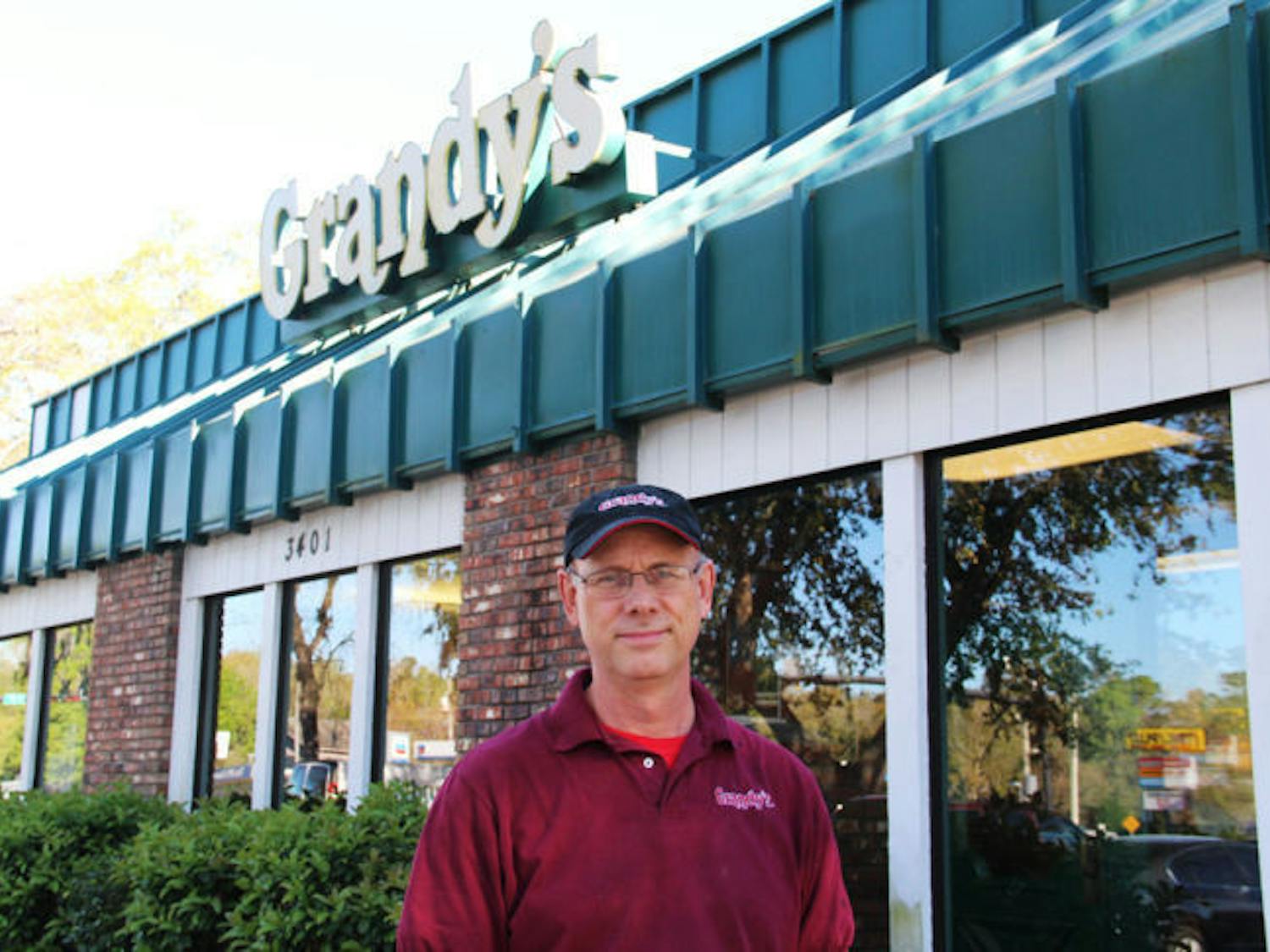 Grandy’s franchise owner Dave Miles stands in front his restaurant on the corner of West University Avenue and Southwest 34th Street on Thursday.