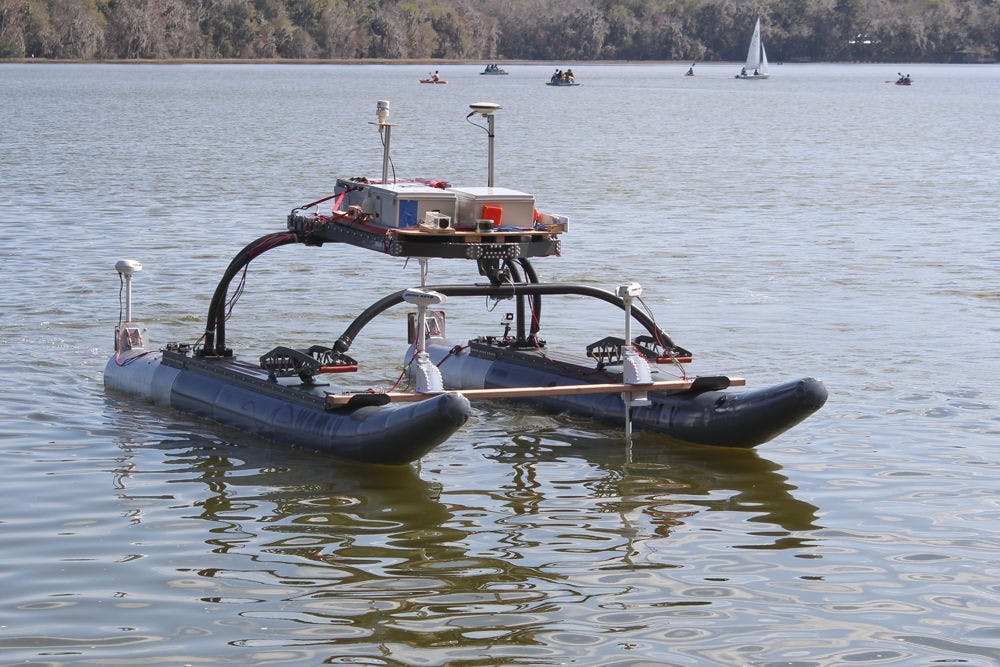 <p>NaviGator, a self-steering boat built by a team of 10 UF students, cruises on Lake Wauberg on Saturday. Built at the UF Machine Intelligence Lab with a $250,000 grant, the boat senses its environment using radar and makes navigational decisions based on what it detects.</p>