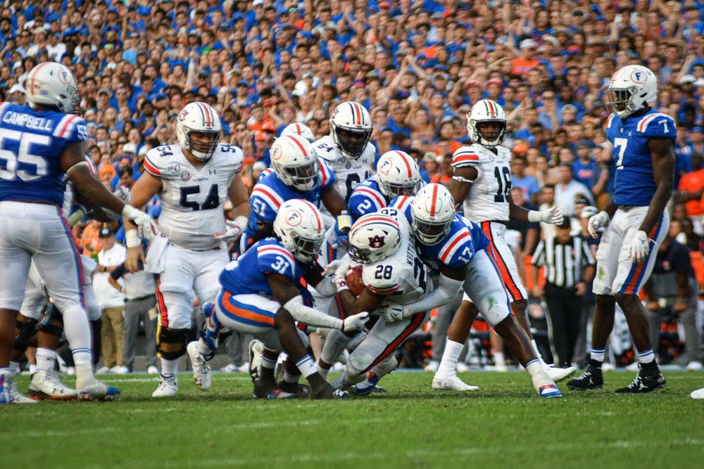 The Gators' defense shut down true freshman Auburn quarterback Bo Nix, sacking him twice and forcing three interceptions — including one from safety Shawn Davis (31). The Tigers were held scoreless during the second half. 