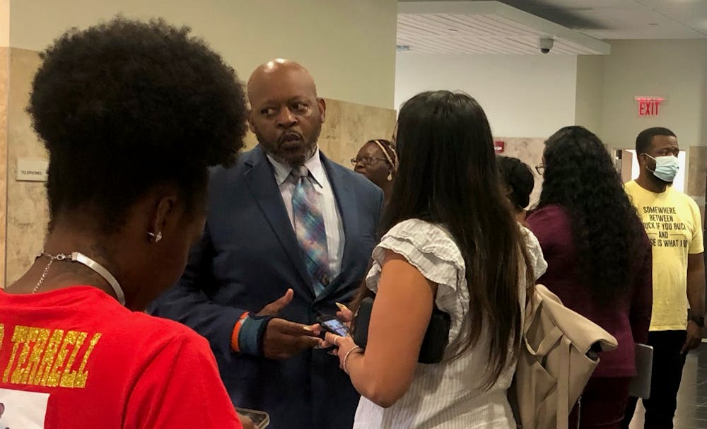 <p>Terrell Bradley’s father Victor Bradley speaks with local activist Danielle Chanzes as they both await Judge Walter Green’s decision outside of the Alachua County Stephen P. Mickle Criminal courtroom Tuesday, July 19, 2022.</p>