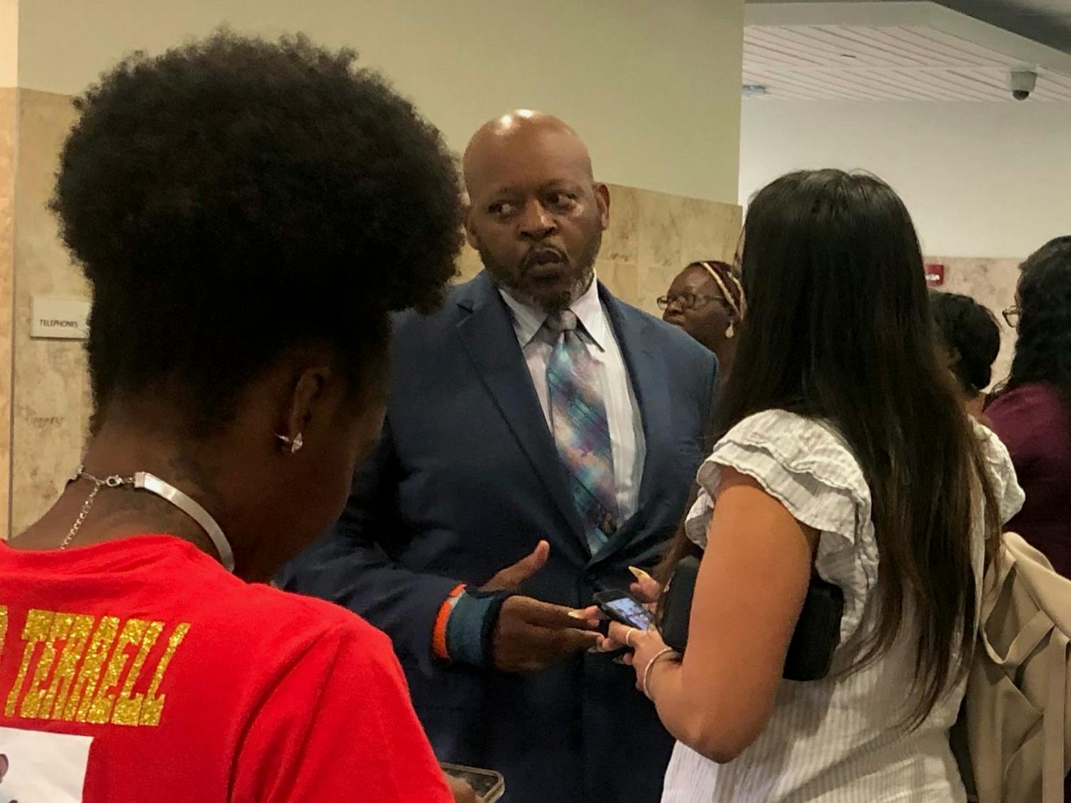 Terrell Bradley’s father Victor Bradley speaks with local activist Danielle Chanzes as they both await Judge Walter Green’s decision outside of the Alachua County Stephen P. Mickle Criminal courtroom Tuesday, July 19, 2022.