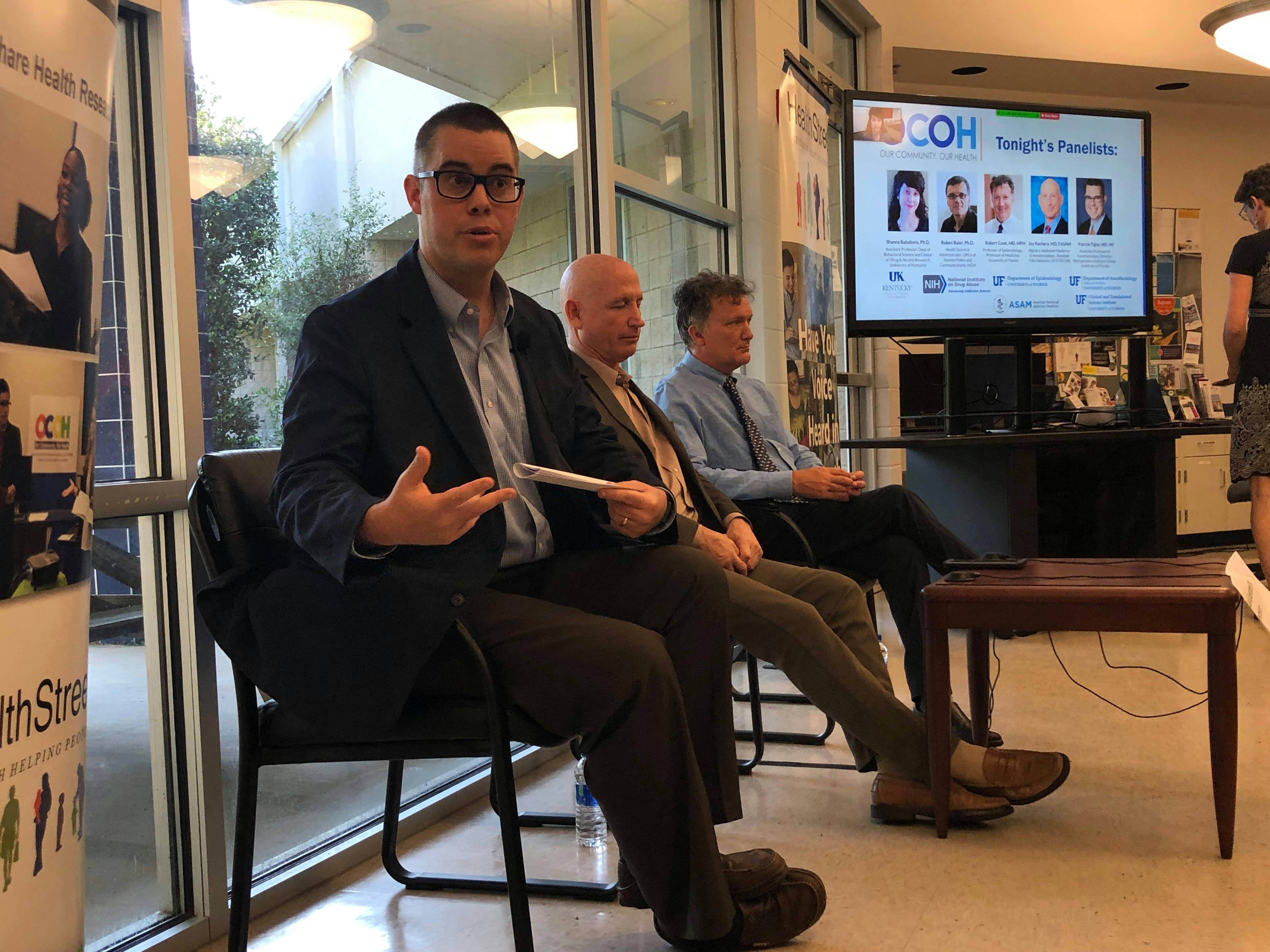 Patrick Tighe (left), a UF associate professor of anesthesiology starts off the Town Hall Medical Marijuana at UF HealthStreet.  He sits alongside two other panelist, Jay Kuchera (middle), a board-certified anesthesiologist and Robert Cook (right), UF Epidemiology Professor. 