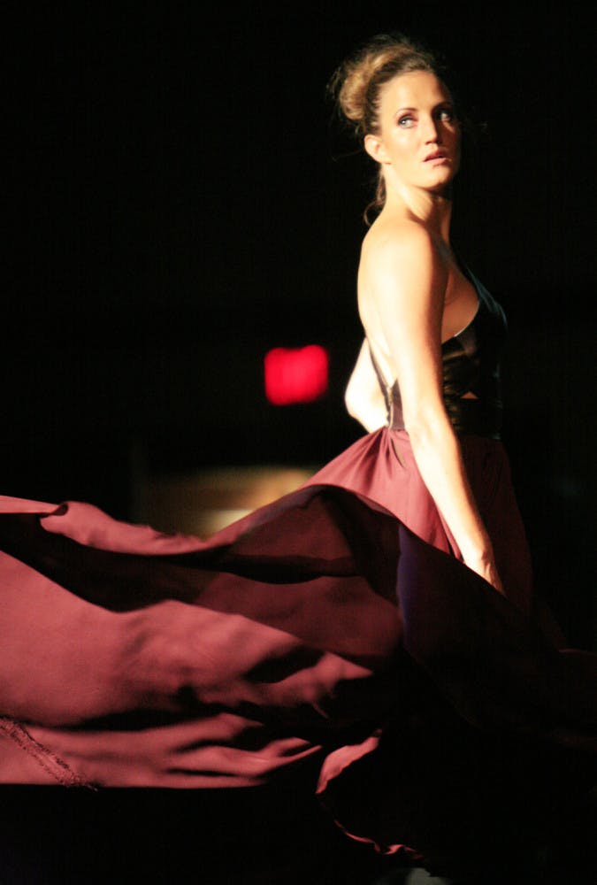 A model flips her skirt as she leaves the runway in the opening look of "Project Runway" season 7 finalist Jay Nicolas Sario's collection Thursday night of Gainesville Fashion Week.