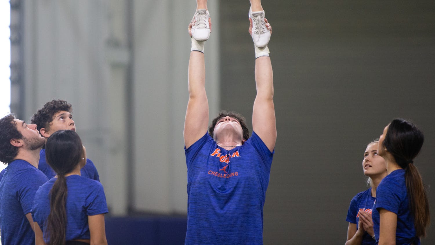 Florida Gators cheerleader Waleed Aref tosses Amrynne Hill during the team's practice on Tuesday, Feb. 20, 2024.
