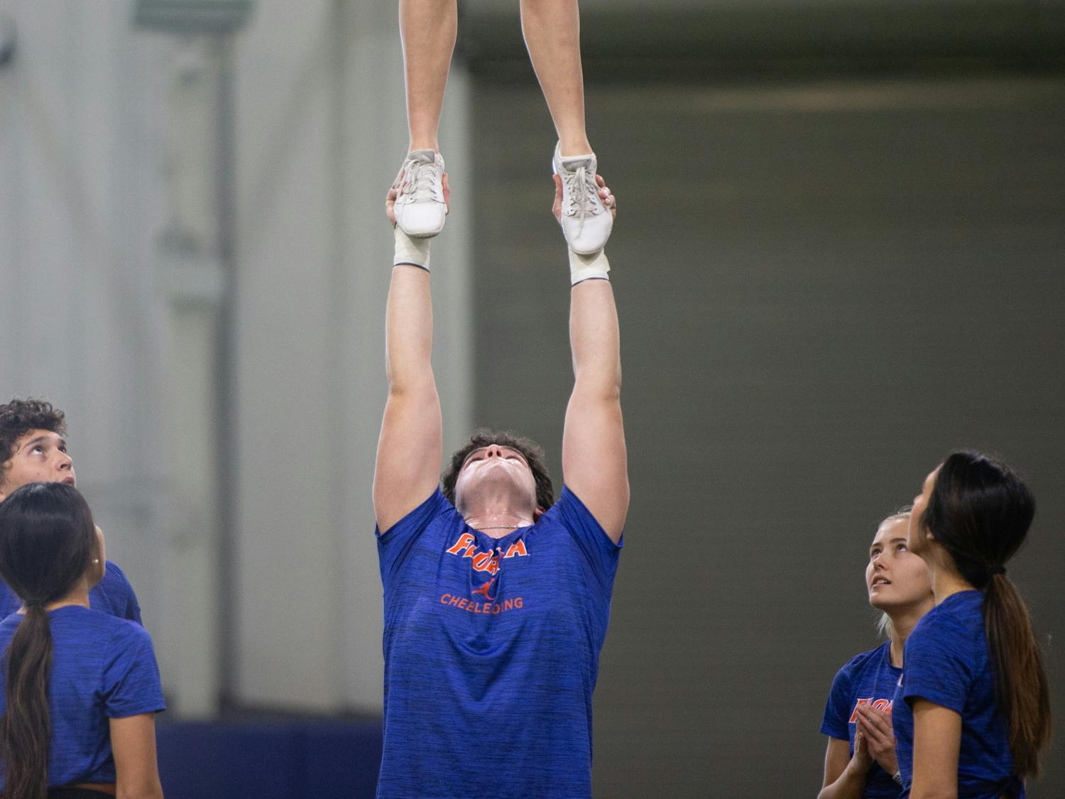 Florida Gators cheerleader Waleed Aref tosses Amrynne Hill during the team's practice on Tuesday, Feb. 20, 2024.
