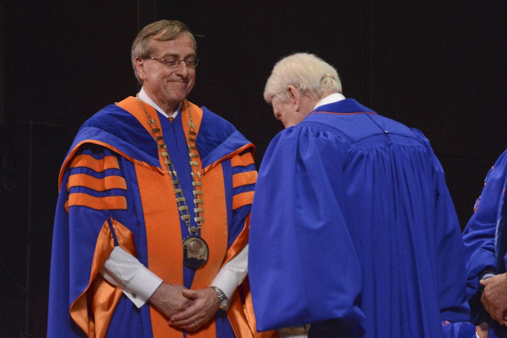 <p>UF President Kent Fuchs receives the presidential chain of office on Dec 4, 2015. The inauguration ceremony officially welcomed him as UF’s 12th president.</p>