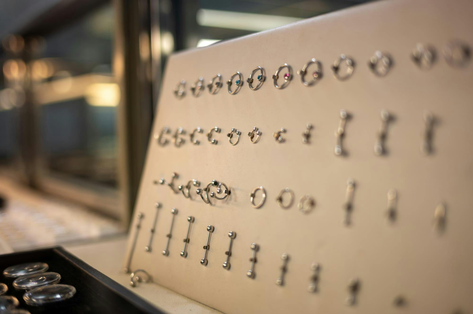 Jewelry options sit in a locked case at Pizzazz Piercing and Tattoo Shop, Wednesday, March 11, 2026, in Gainesville, Fla.
