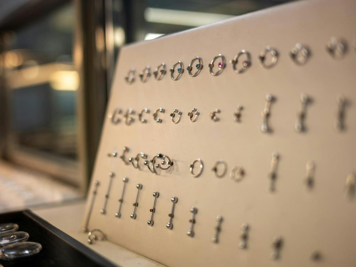 Jewelry options sit in a locked case at Pizzazz Piercing and Tattoo Shop, Wednesday, March 11, 2026, in Gainesville, Fla.