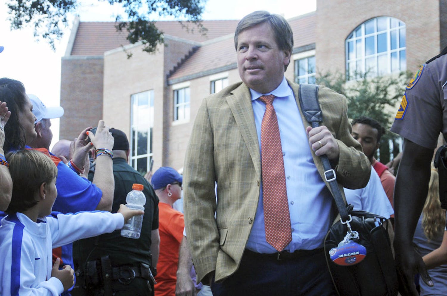 UF coach Jim McElwain walks to the stadium before Florida's 38-10 win against Ole Miss on Oct. 3, 2015, at Ben Hill Griffin Stadium.