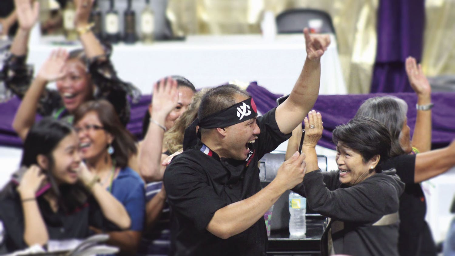 Chef Nester Espartero of Volcanic Sushi + Sake celebrates his team's Iron Chef victory at Tastes of Greater Gainesville 2018.