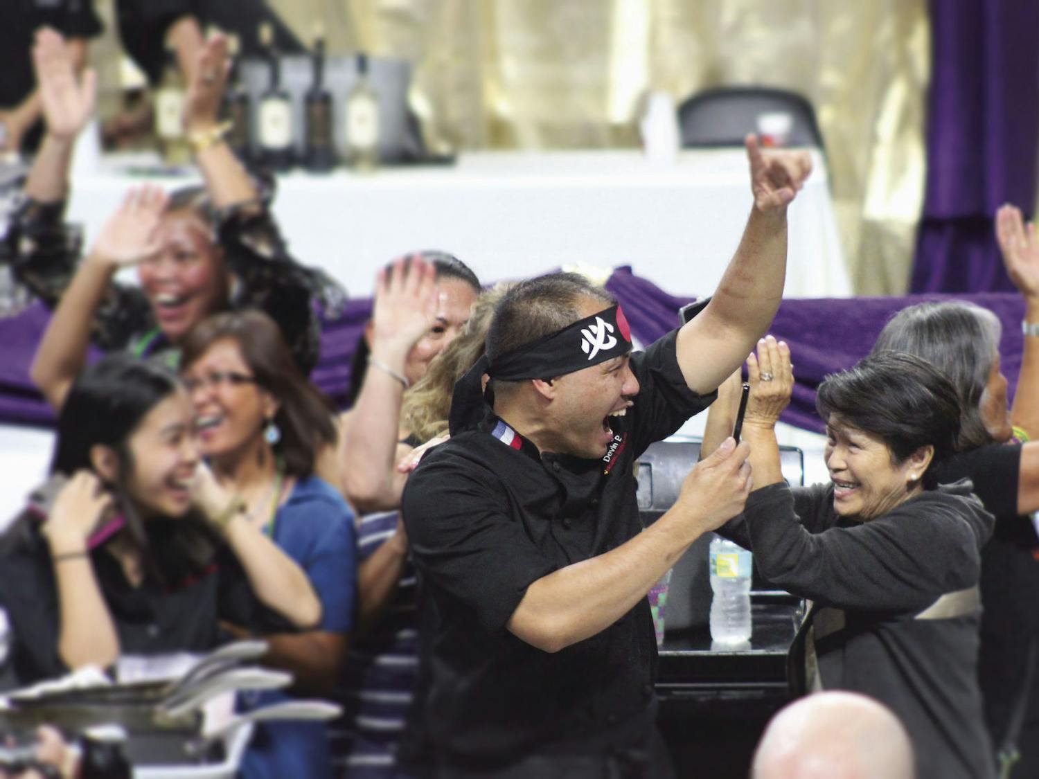 Chef Nester Espartero of Volcanic Sushi + Sake celebrates his team's Iron Chef victory at Tastes of Greater Gainesville 2018.