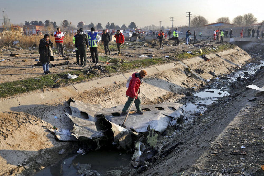<p>Rescue workers inspect the scene where a Ukrainian plane crashed in Shahedshahr, southwest of the capital Tehran, Iran, Wednesday, Jan. 8, 2020. A Ukrainian airplane with more than 170 people crashed on Wednesday shortly after takeoff from Tehran's main airport, killing all onboard. (AP Photo/Ebrahim Noroozi)</p>