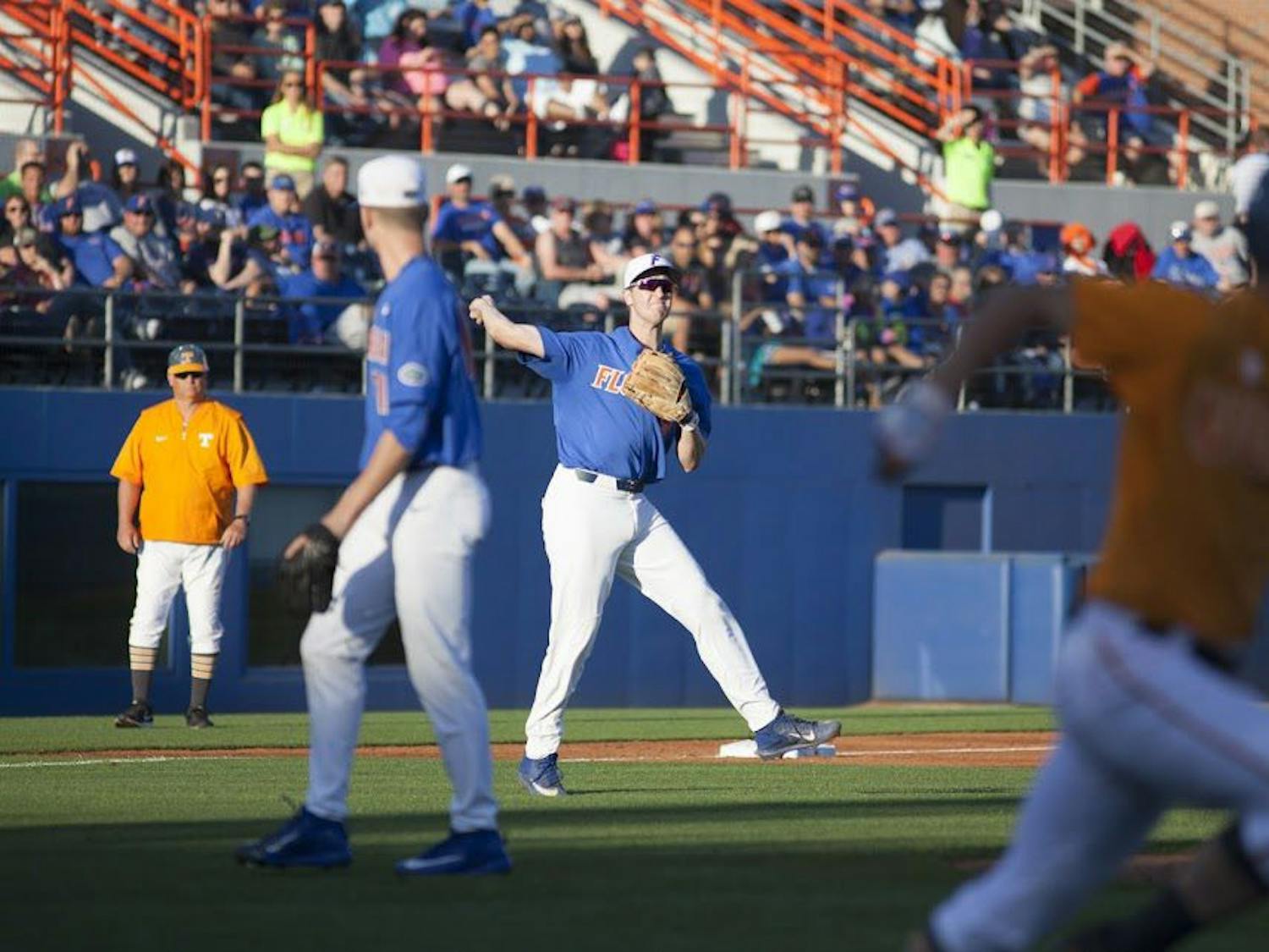 UF infielder Christian Hicks throws to first on a ground ball during Florida's 3-2 loss in 10 innings to Tennessee on April 8, 2017, at McKethan Stadium.