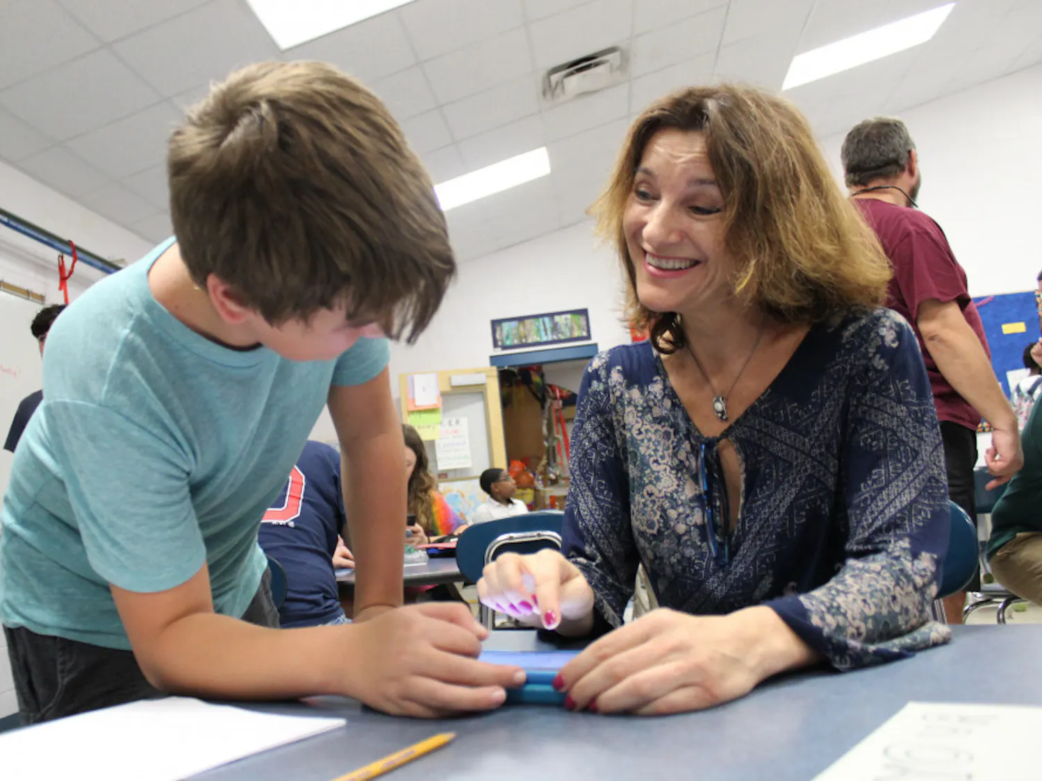 Amaya Hartel and her son Lander, 12, work together on an experiment about infrared consumption on mobile devices at the fourth annual Family Science and Robotics Night.