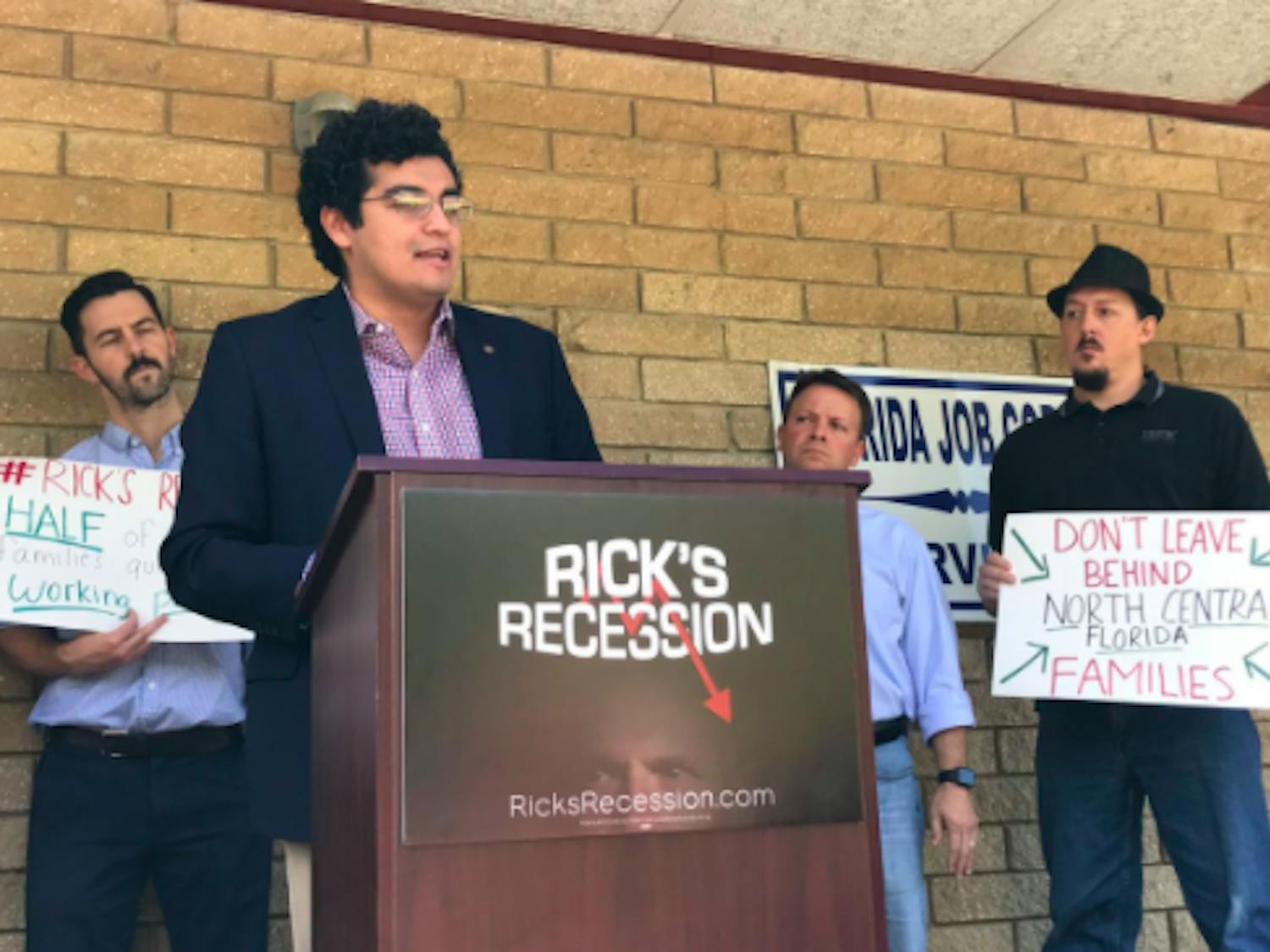City Commissioner David Arreola speaks outside of the closed Gainesville Job Corps Office on Wednesday for the Gainesville stop in the Rick’s Recession tour.