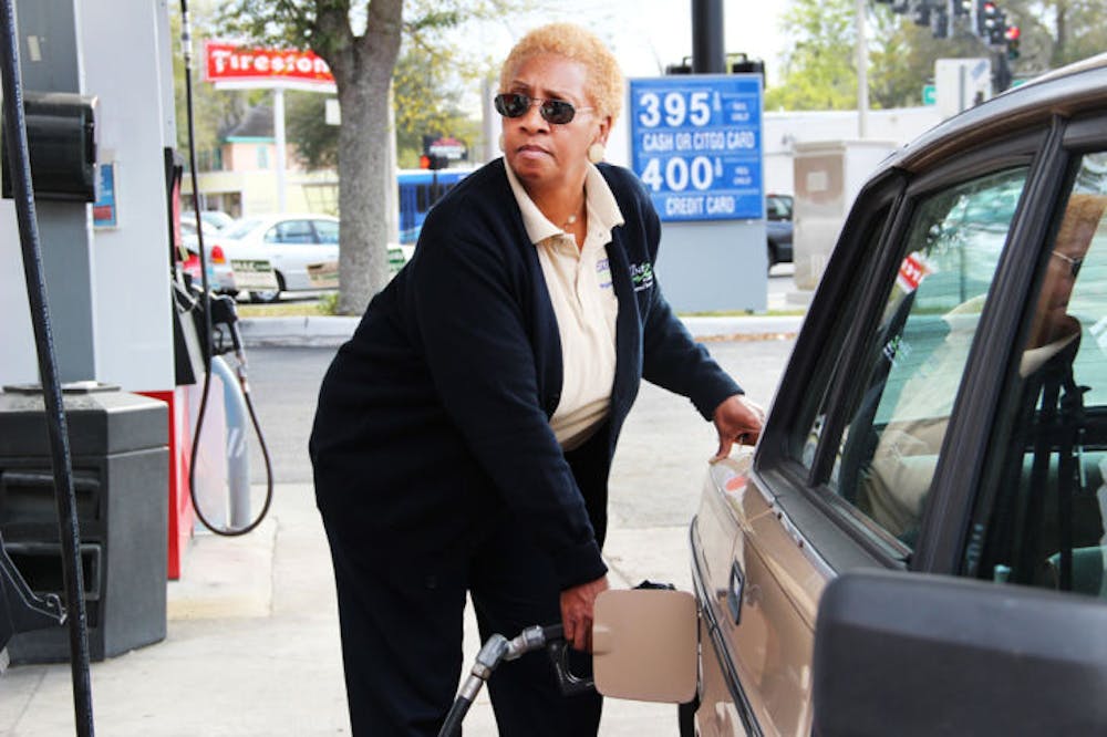<p>Janet Blakney, a 59-year-old Regional Transit System bus driver, pays $3.95 a gallon of regular unleaded gasoline at the Citgo at the corner of North Main Street and Northeast Eighth Avenue.</p>