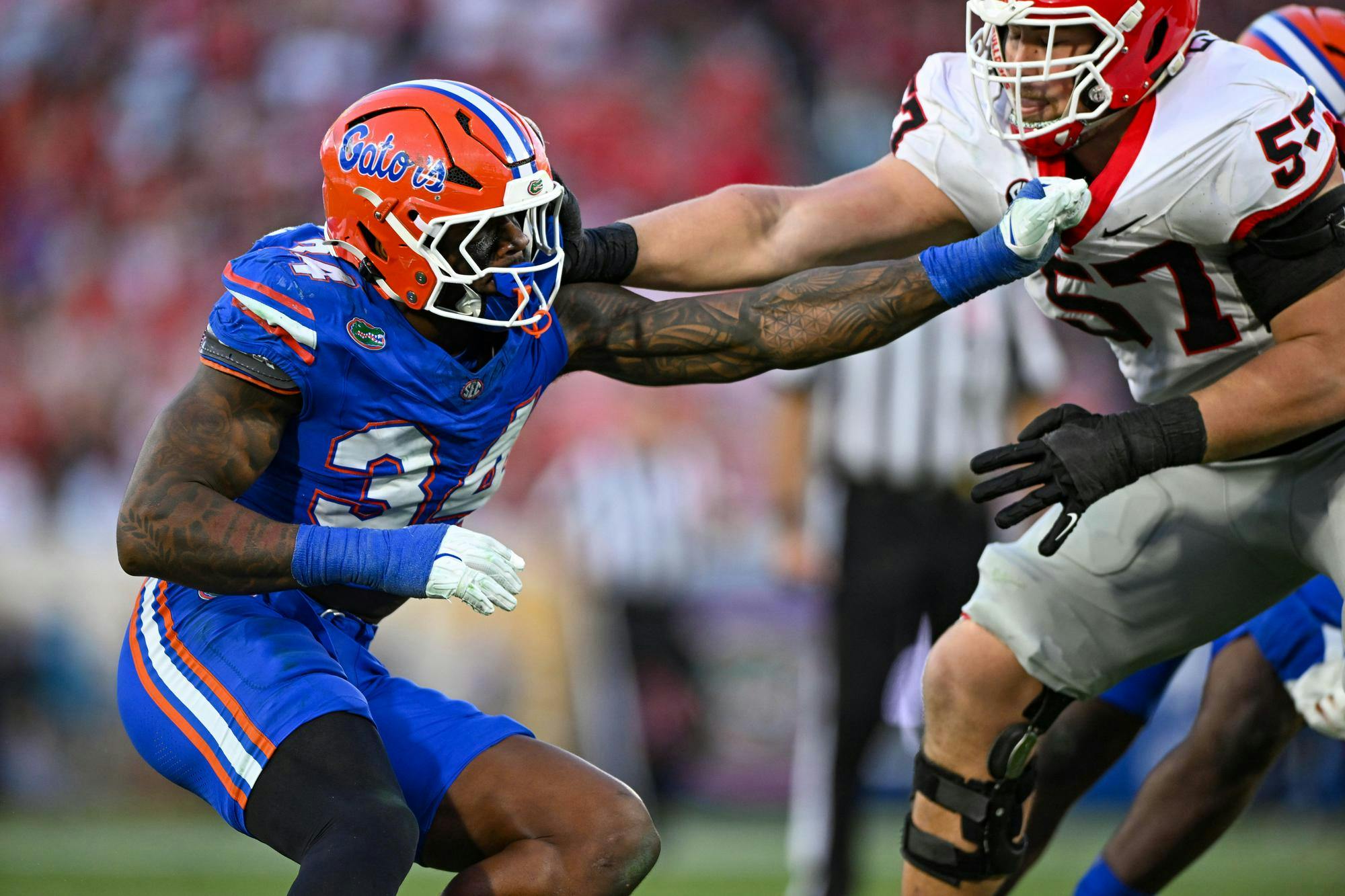 Florida edge rusher George Gumbs Jr. (34) holds Georgia offensive lineman Monroe Freeling during an NCAA college football game, Saturday, Nov. 1, 2025, in Jacksonville, Fla. Both Gumbs and Freeling are attending the 2026 NFL Draft Combine.
