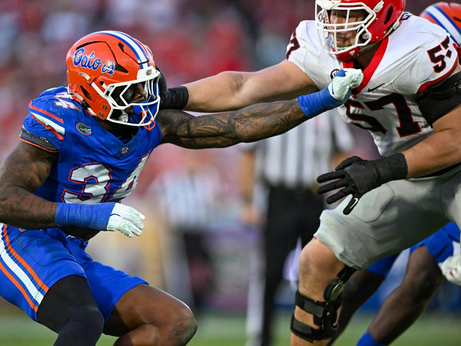 Florida edge rusher George Gumbs Jr. (34) holds Georgia offensive lineman Monroe Freeling during an NCAA college football game, Saturday, Nov. 1, 2025, in Jacksonville, Fla. Both Gumbs and Freeling are attending the 2026 NFL Draft Combine.