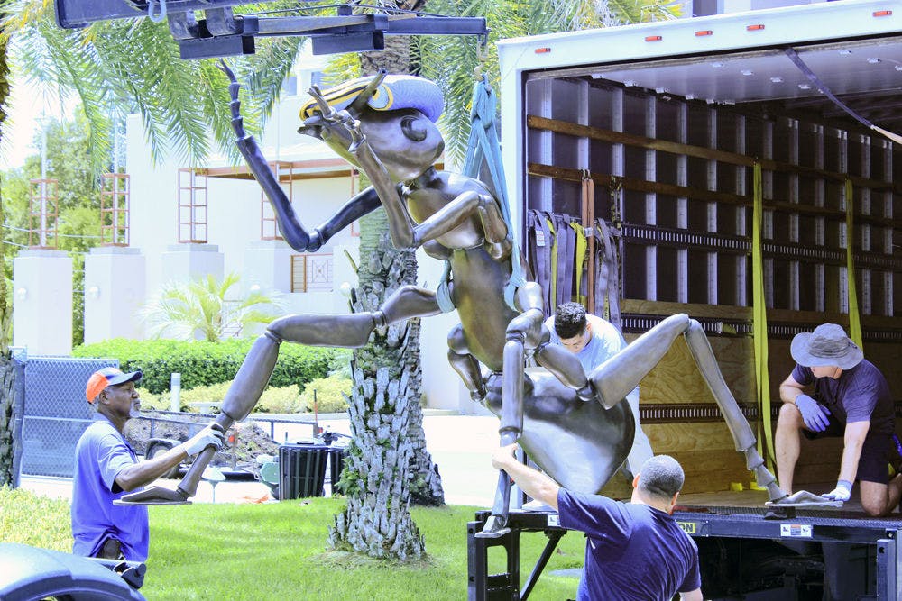 Giant Ants Two 1,100-pound bronze ant statues are unloaded Tuesday at the Florida Museum of Natural History. They are a temporary installation by artist Susan Cochran.