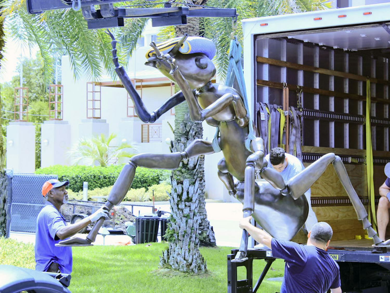 Giant Ants Two 1,100-pound bronze ant statues are unloaded Tuesday at the Florida Museum of Natural History. They are a temporary installation by artist Susan Cochran.