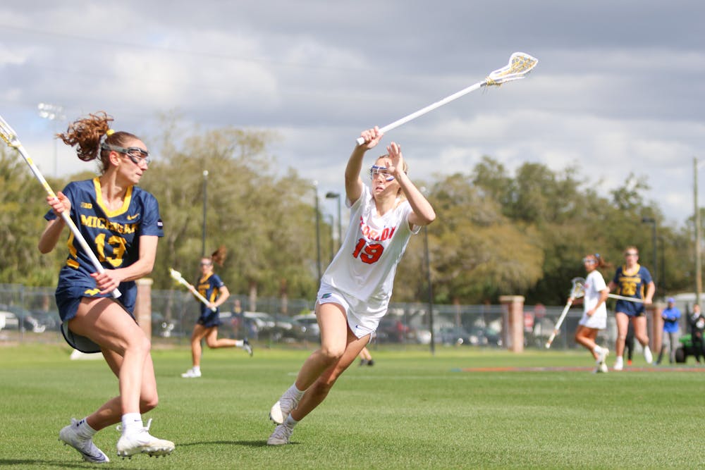 Florida attacker Maggi Hall defends a Michigan shot during the Gators' 17-8 win against the No. 17 Wolverines Sunday, Feb. 12, 2023.